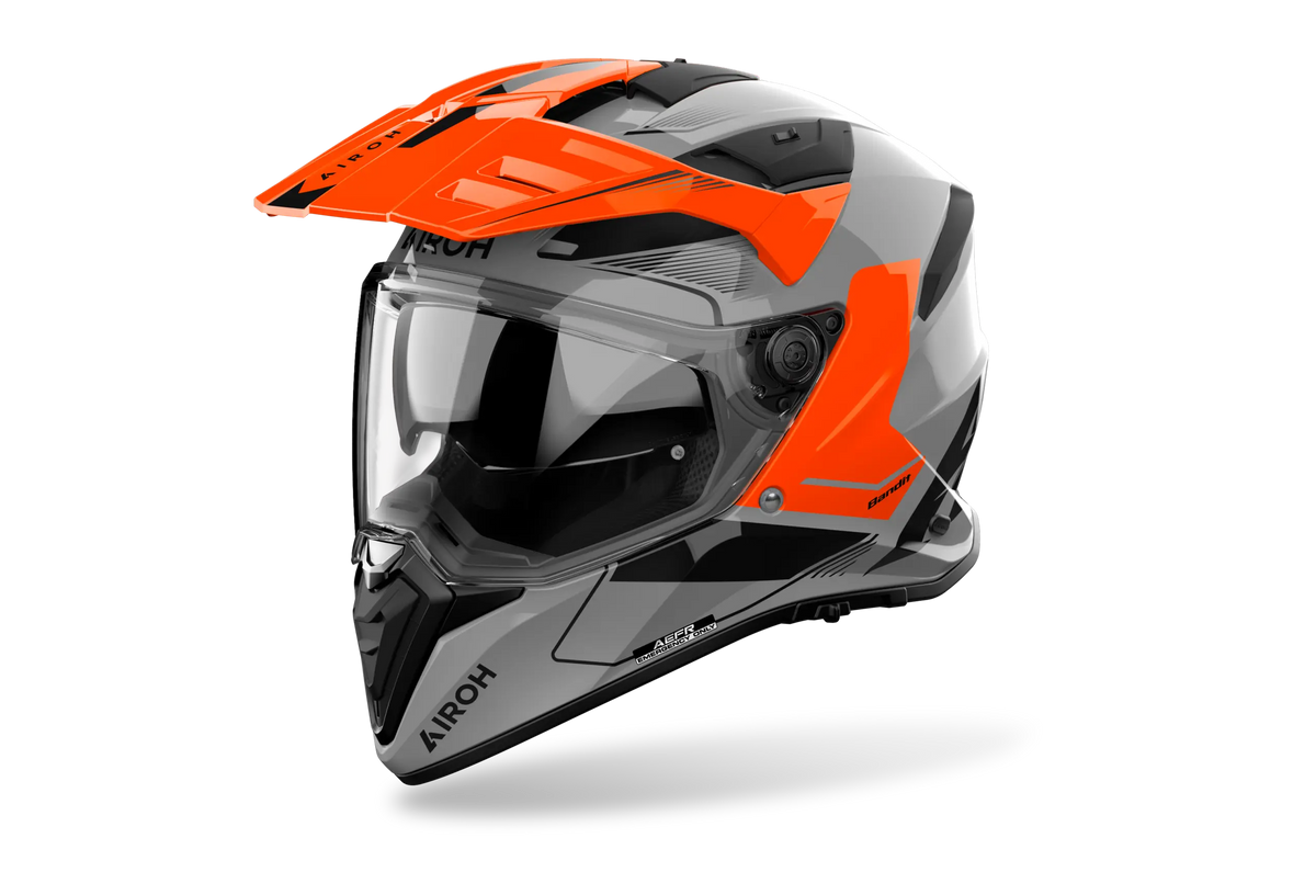 Airoh Bandit BADX-X Tune Arancio Lucido (BAT32), casco adventure visto di tre quarti dal lato sinistro, grafica grigia e nera con inserti arancio, lucida