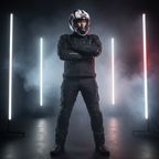 Motociclista in piedi fra barre luminose bianche con il casco Airoh Valor Nexy