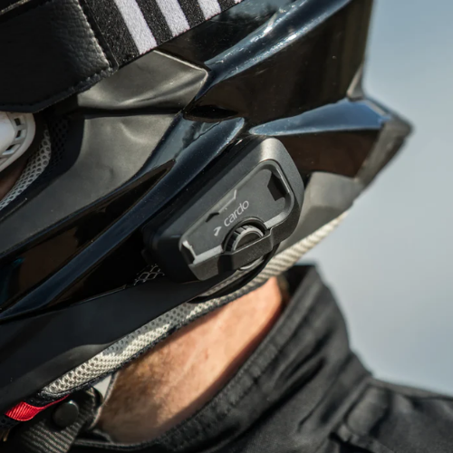 Motociclista con casco integrale e interfono Cardo Freecom 4X montato sulla calotta