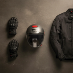 Casco jet Givi 12.5 titanio opaco fotografato dall'alto accanto a guanti e giacca da moto